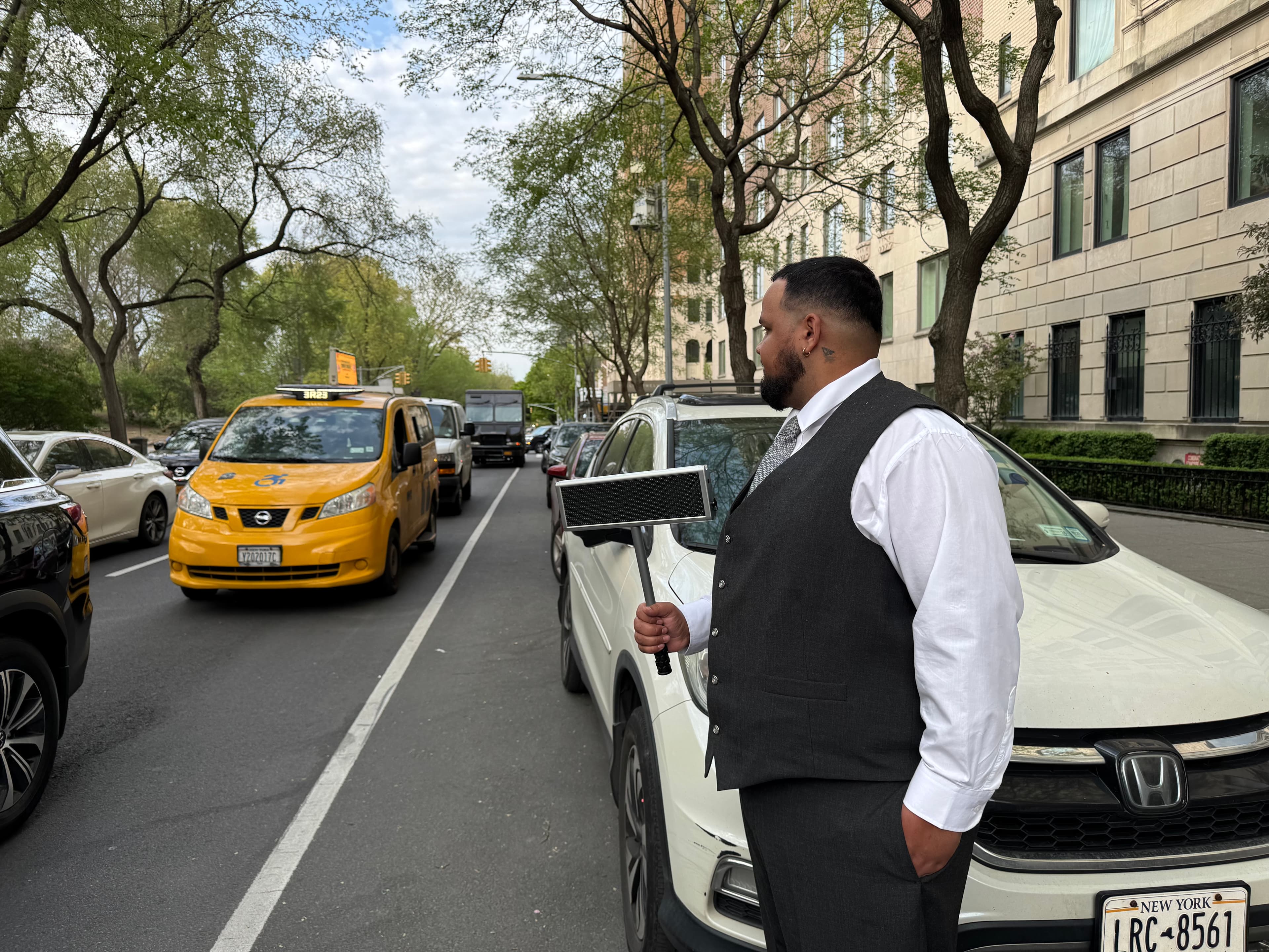 Valet Network driver curbside in NYC traffic